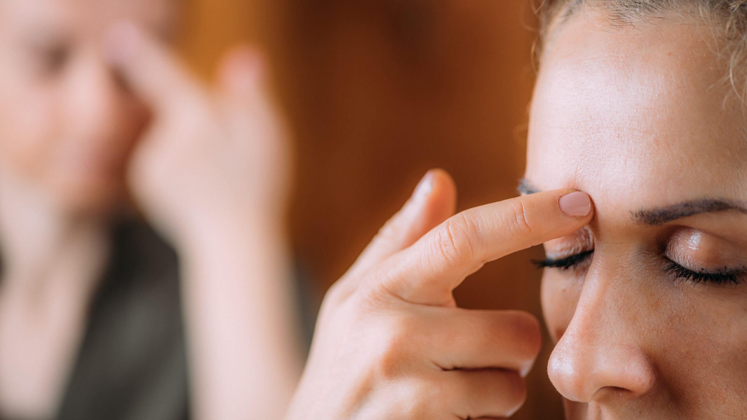 Someone EFT tapping their forehead to reduce anxiety