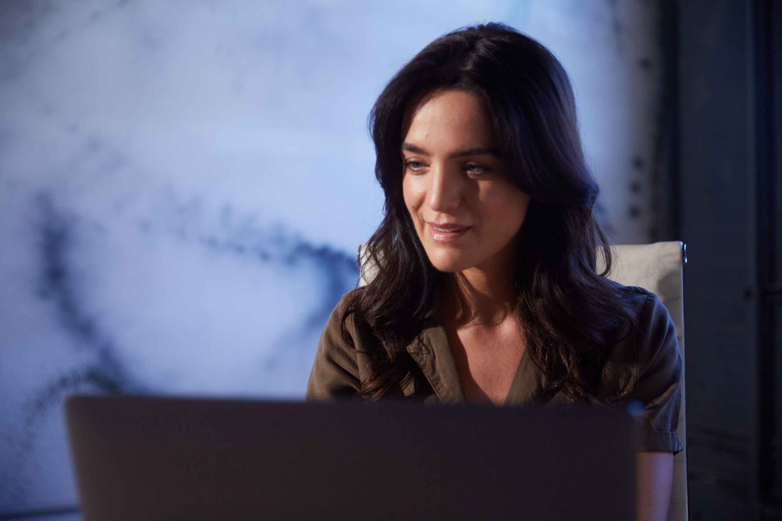 Woman staring at a laptop screen