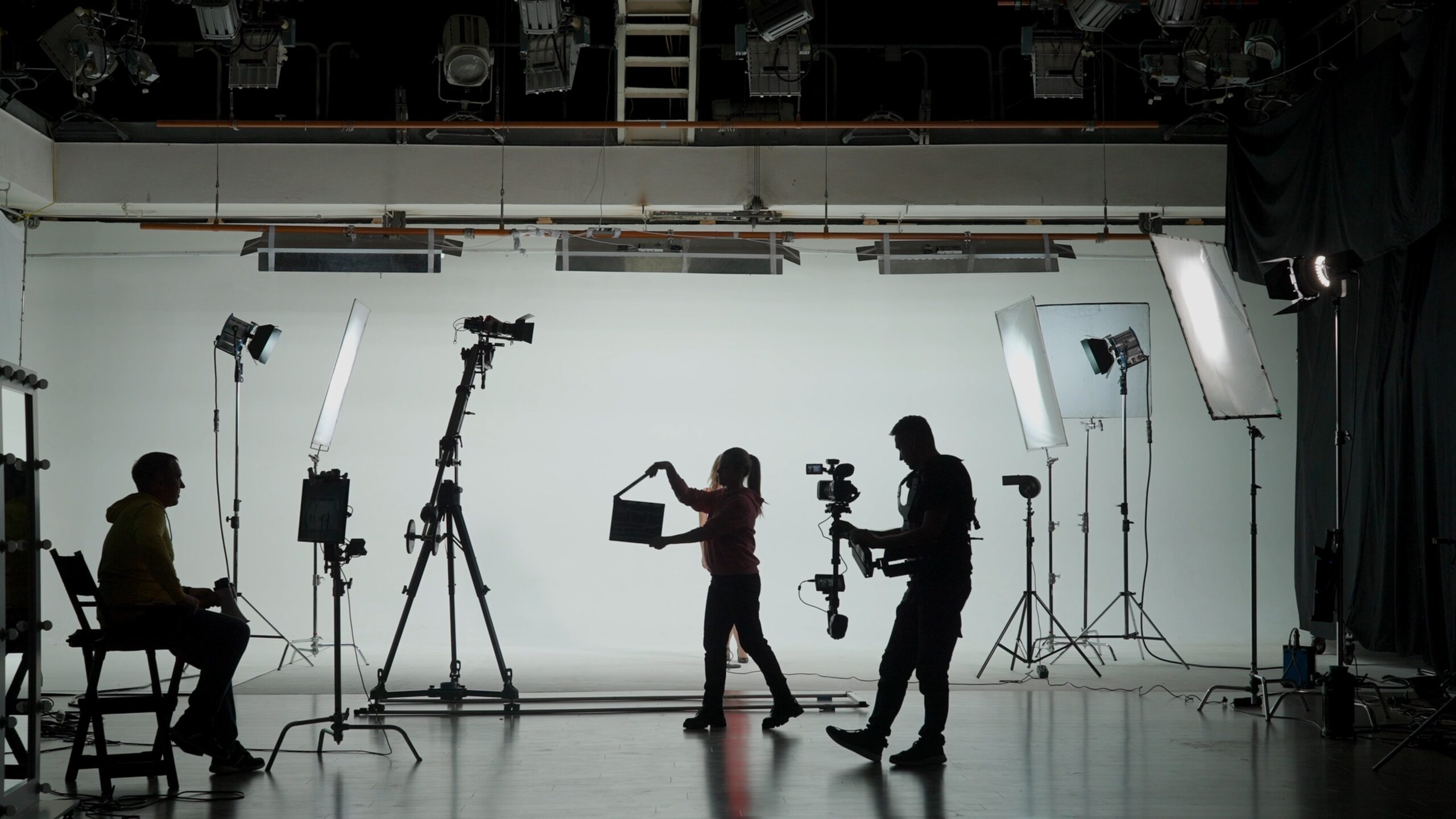 Silhouettes of a film crew on set
