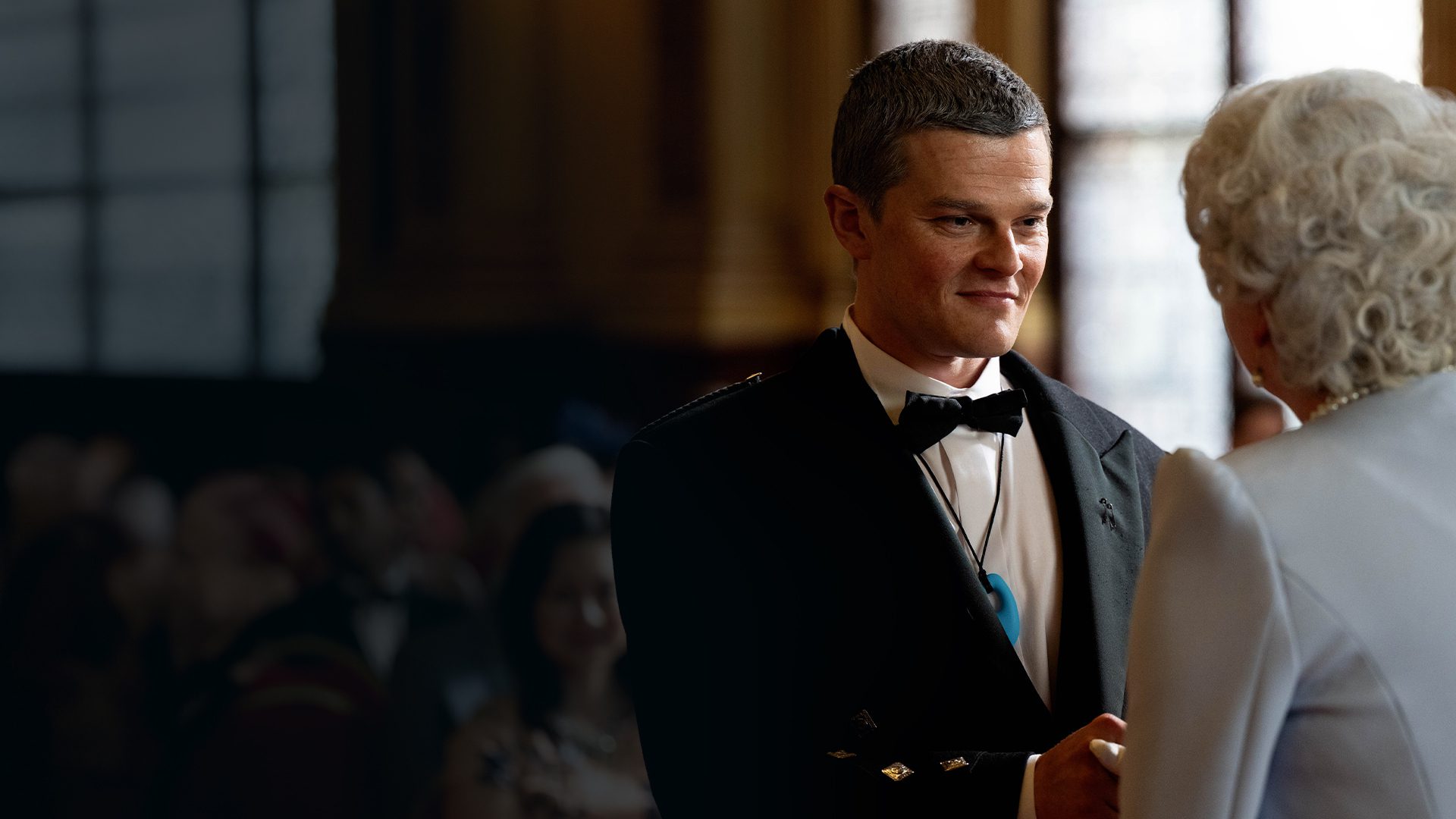 Robert Aramayo shaking hands with the Queen in 'I Swear'