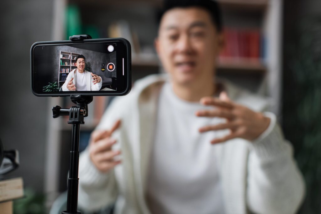 An actor filming a self-tape at home on their phone