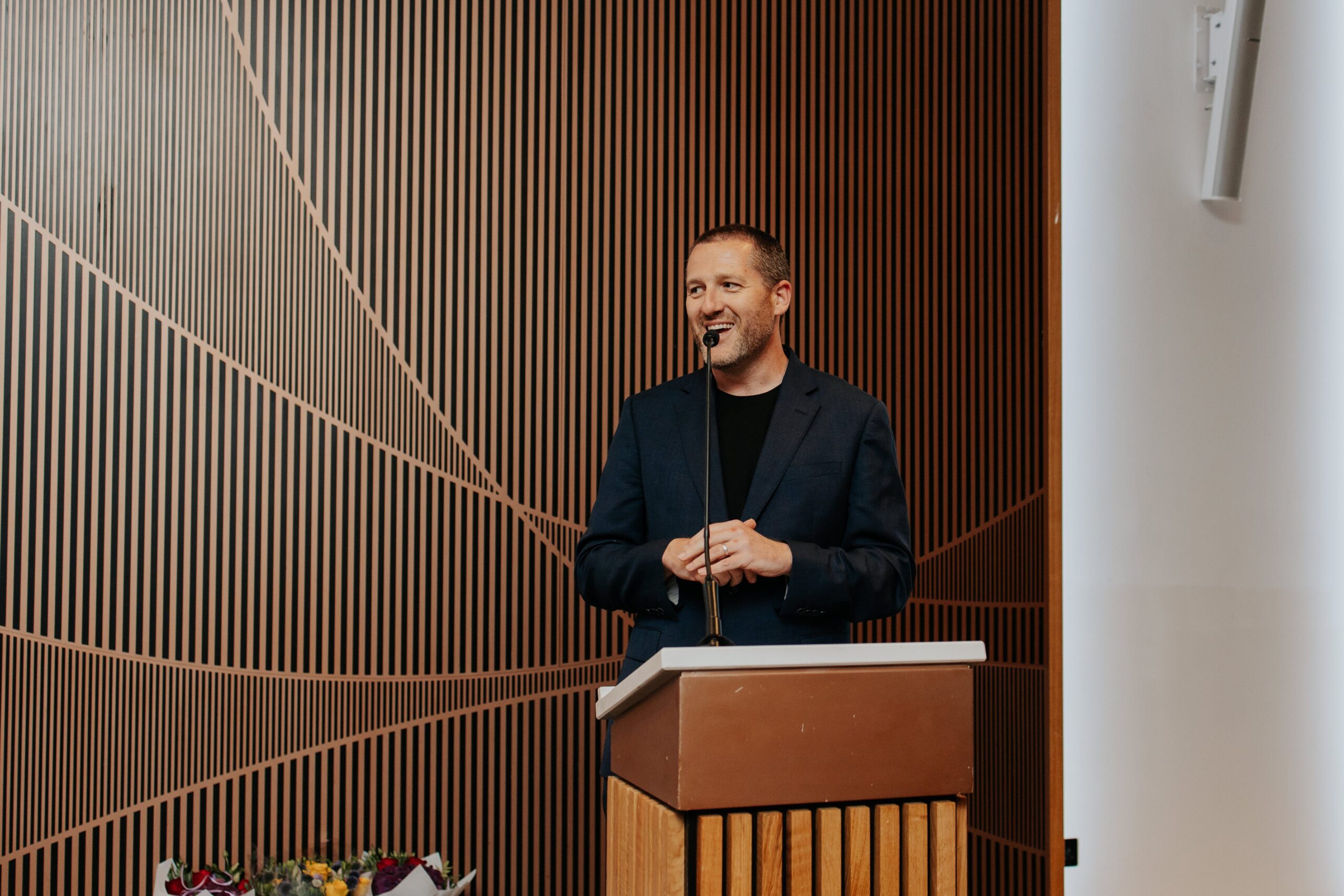 Spotlight MD Matt Hood speaking at a podium