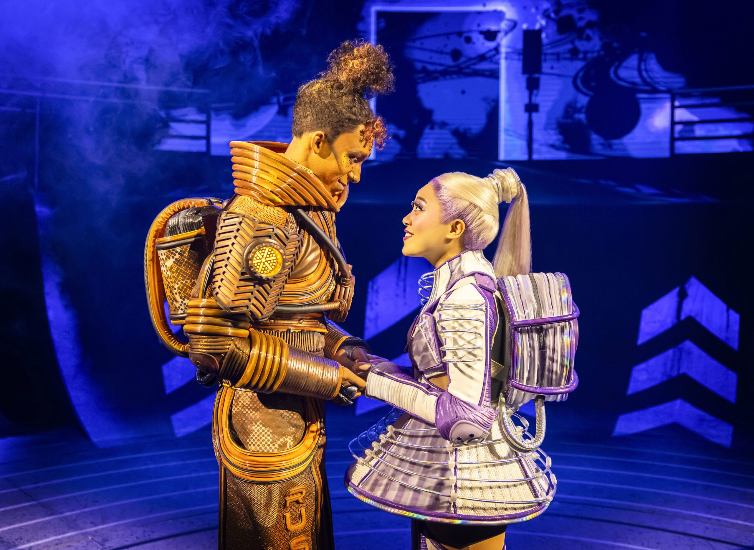 Jeevan Braich as 'Rusty' and Kayna Montecillo as 'Pearl' in 'Starlight Express' looking at each other lovingly