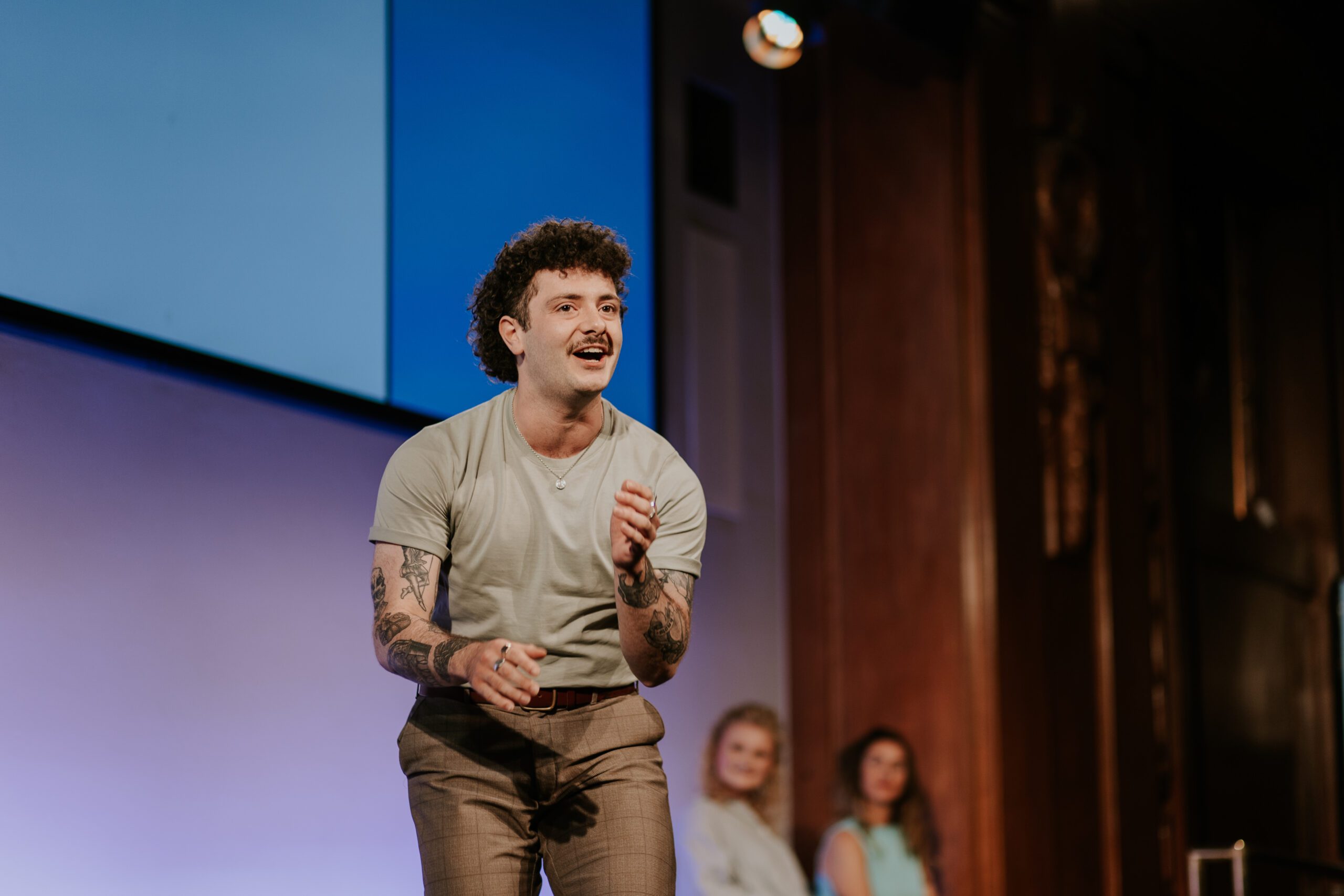 Actor Lucas Albion performing a monologue on-stage at the Spotlight Prize 2023