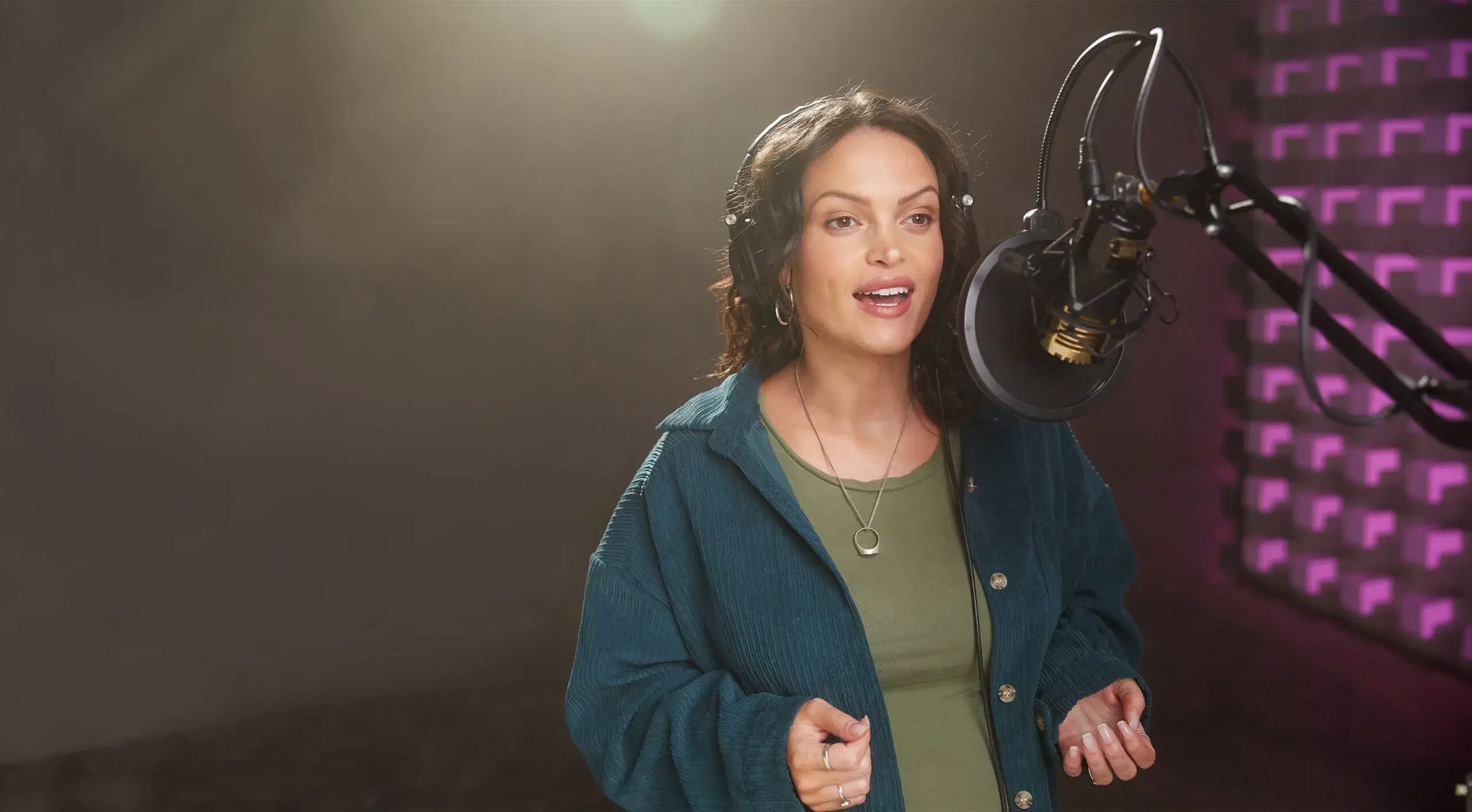 Image of a woman at a recording mic